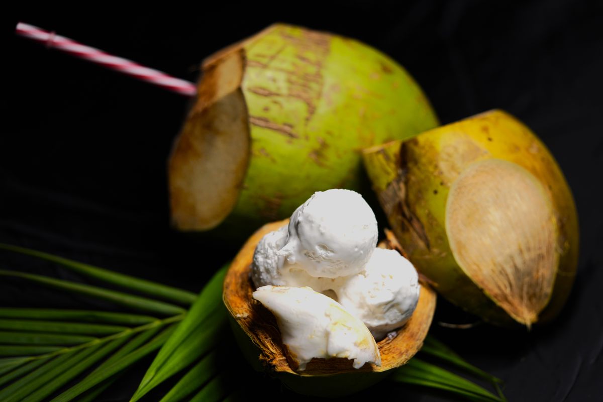 Tender coconut ice cream served inside a fresh green coconut shell